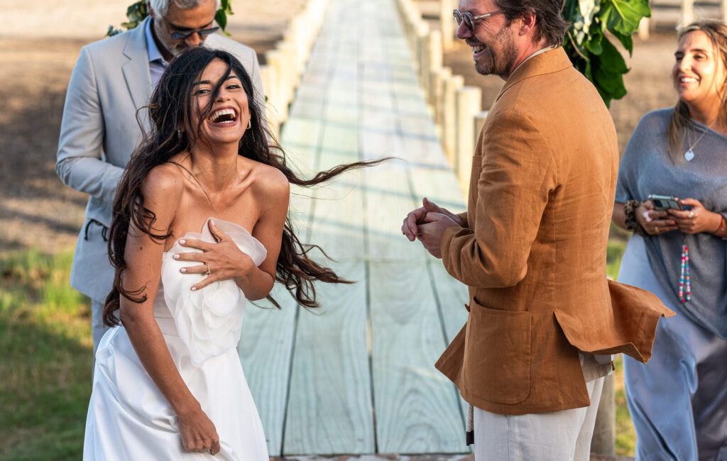 The bride laughing with her hair in the wind